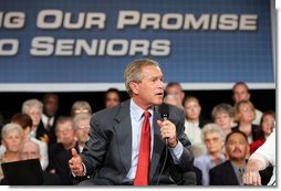 President George W. Bush makes a point during a conversation on Medicare-approved prescription drug discount cards in Liberty, Mo., June 14, 2004.  White House photo by Susan Sterner