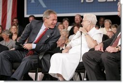 President George W. Bush laughs with senior Wanda Blackmore during a conversation on Medicare-approved prescription drug discount cards in Liberty, Mo., June 14, 2004.  White House photo by Paul Morse
