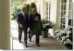 President George W. Bush and Hamid Karzai of Afghanistan walk along the colonnade after holding a joint press conference in the Rose Garden Tuesday, June 15, 2004.  White House photo by Paul Morse