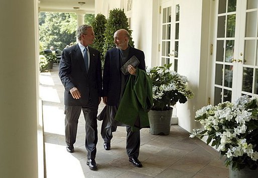 President George W. Bush and Hamid Karzai of Afghanistan walk along the colonnade after holding a joint press conference in the Rose Garden Tuesday, June 15, 2004. White House photo by Paul Morse.