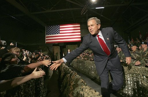 President George W. Bush greets Fort Lewis military personnel in the audience during his introduction at Fort Lewis, Washington, Friday, June 18, 2004. White House photo by Eric Draper.