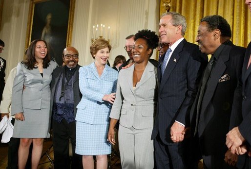 President George W. Bush and Mrs. Laura Bush pose with jazz musicians after a performance to honor Black Music Month in the East Room of the White House on June 22, 2004. White House photo by Paul Morse