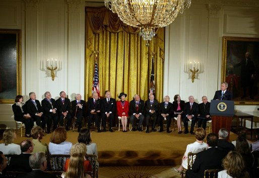 The recipients of the Presidential Medal of Freedom listen to President George W. Bush after receiving their awards in the East Room of the White House on June 23, 2004. White House photo by Paul Morse