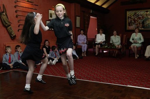 Laura Bush watches traditional Irish dancing during a children’s performance at Dromoland Castle with, from left, Susie Evans, Marna Schnabel and Margaret Kenny in Shannon, Ireland, Saturday, June 26, 2004. White House photo by Joyce Naltchayan