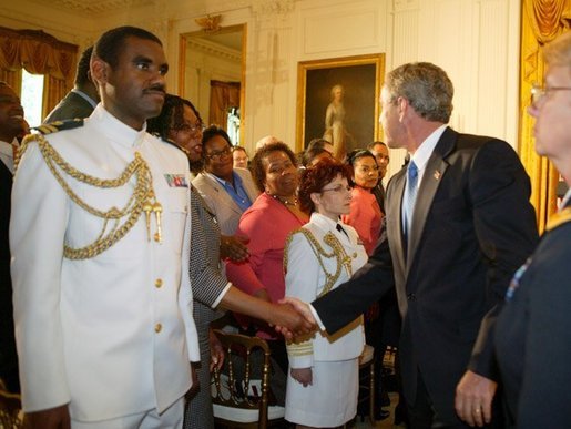 President George W. Bush greets the audience during a reception commemorating the 40th Anniversary of the Civil Rights Act at the White House on July 1, 2004. White House photo by Paul Morse