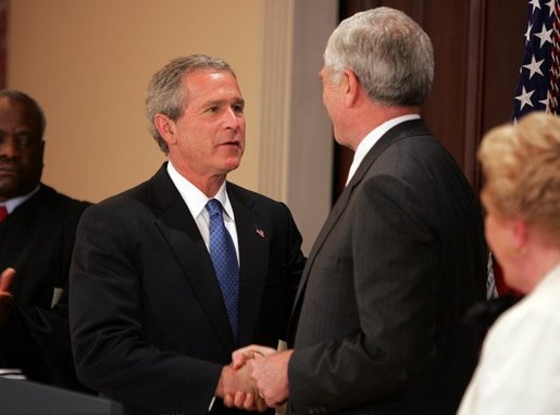President George W. Bush congratulates Senator John Danforth as the new representative of the United States to the United Nations after a swearing-in ceremony in the Eisenhower Executive Office Building on July 1, 2004. White House photo by Paul Morse