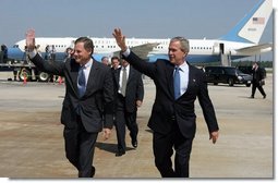 President George W. Bush arrives in Raleigh, North Carolina with Congressman Richard Burr on Wednesday July 7, 2004. The President was in North Carolina to meet with pending North Carolina judicial nominees.   White House photo by Paul Morse