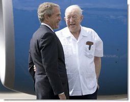 President George W. Bush chats with Freedom Corps greeter Scotty Maconochie after landing in Waterford, Michigan on Wednesday July 7, 2004.  White House photo by Paul Morse