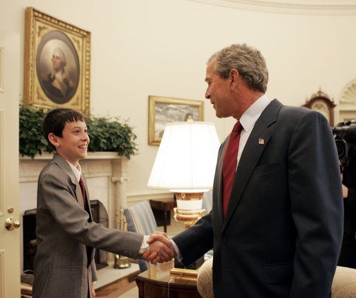 President George W. Bush welcomes the 2004 Scripps Howard Spelling Bee champion, David Tidmarsh, 14, of South Bend, Ind., to the Oval Office, Thursday, July 8, 2004. David bested 265 other contestants from across the nation to win the prestigious spelling honors. He is the first student from Indiana to win the contest in 76 years. White House photo by Eric Draper.