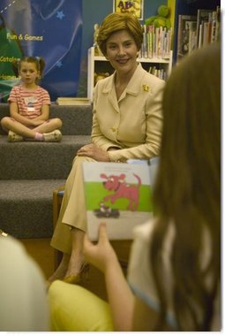 Laura Bush listens to children read while participating in the No Child Left Behind Summer Reading Program at the Portsmouth Public Library in Portsmouth, New Hampshire, Friday, July 9, 2004.  White House photo by Joyce Naltchayan