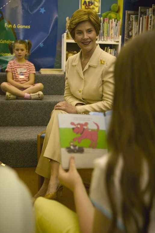 Laura Bush listens to children read while participating in the No Child Left Behind Summer Reading Program at the Portsmouth Public Library in Portsmouth, New Hampshire, Friday, July 9, 2004. White House photo by Joyce Naltchayan