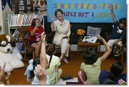 Laura Bush discusses the importance of reading with children participating in the No Child Left Behind Summer Reading Program at the Portsmouth Public Library in Portsmouth, New Hampshire, Friday, July 9, 2004.  White House photo by Joyce Naltchayan