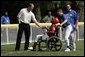 Former Major League pitcher Jim Abbott congratulates a player from the Challenger Phillies from Middletown, Delaware at Tee Ball on the South Lawn at the White House on Sunday July 11, 2004.  White House photo by Paul Morse