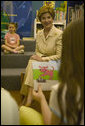 Laura Bush listens to children read while participating in the No Child Left Behind Summer Reading Program at the Portsmouth Public Library in Portsmouth, New Hampshire, Friday, July 9, 2004. White House photo by Joyce Naltchayan