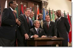 President George W. Bush signs into law the African Growth and Opportunity Act (AGOA) Acceleration Act of 2004 in the Dwight D. Eisenhower Executive Office Building Tuesday, July 13, 2004.  White House photo by Paul Morse