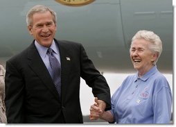 President George W. Bush meets USA Freedom Corps Greeter Grace McCarthy, 83, upon his arrival in Marquette, Mich., Tuesday, July 13, 2004. Ms. McCarthy has volunteered more than 4,000 hours with local groups, including the Retired and Senior Volunteer Program in Marquette.  White House photo by Eric Draper