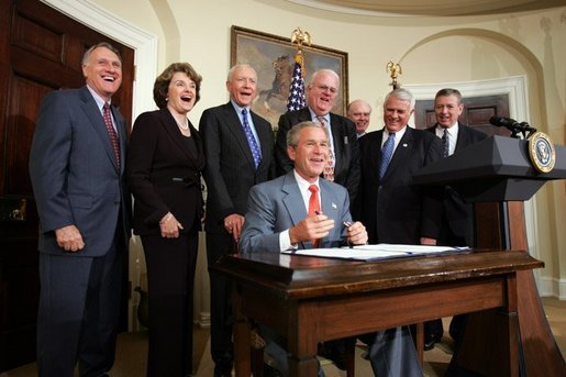 President George W. Bush laughs with fellow lawmakers during the signing ceremony of the Identity Theft Penalty Enhancement Act in the Roosevelt Room of the White House Thursday, July 15, 2004. White House photo by Paul Morse