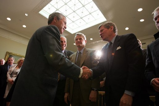 President George W. Bush greets Senator Tim Johnson, D-S.D., after a signing ceremony for the Identity Theft Penalty Enhancement Act in the Roosevelt Room of the White House Thursday, July 15, 2004. White House photo by Paul Morse.