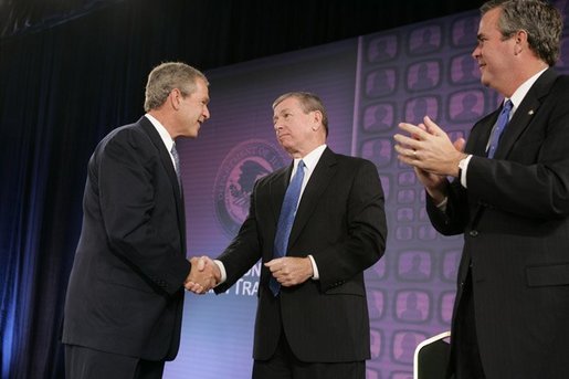 President George W. Bush is congratulated by Attorney General John Ashcroft and Florida Governor Jeb Bush after making remarks at the National Training Conference on Combating Human Trafficking in Tampa, Florida on Friday July 16, 2004. White House photo by Paul Morse