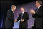 President George W. Bush is congratulated by Attorney General John Ashcroft and Florida Governor Jeb Bush after making remarks at the National Training Conference on Combating Human Trafficking in Tampa, Florida on Friday July 16, 2004. White House photo by Paul Morse