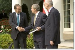 Accompanied by Chairman Thomas Kean, left, and Vice Chairman Lee Hamilton of the 911 Commission, President George W. Bush addresses the press during the presentation of the Commission's report in the Rose Garden Thursday, July 22, 2004.  White House photo by Eric Draper