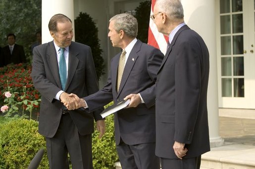 Accompanied by Chairman Thomas Kean, left, and Vice Chairman Lee Hamilton of the 911 Commission, President George W. Bush addresses the press during the presentation of the Commission's report in the Rose Garden Thursday, July 22, 2004. White House photo by Eric Draper.
