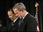 President George W. Bush joins Marc Morial, President of the National Urban League, in prayer on stage before delivering remarks in Detroit, Mich., Friday, July 23, 2004. White House photo by Eric Draper