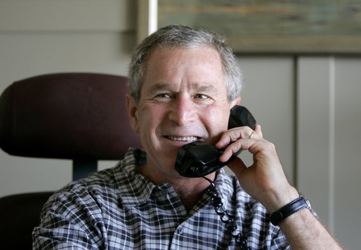 President George W. Bush congratulates Lance Armstrong on his sixth Tour de France win during a phone call from the Bush Ranch in Crawford, Texas, Sunday, July 25, 2004. White House photo by Eric Draper.