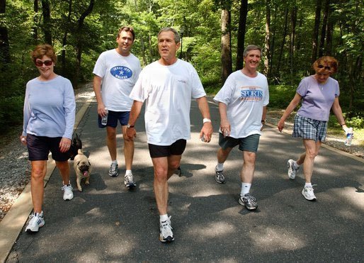 President George W. Bush and First Lady Laura Bush complete a four mile walk with brother Marvin Bush, left, Chief of Staff Andy Card and wife Kathleene after undergoing a colorectal screening procedure at Camp David, Saturday morning, June 29. File Photo. White House photo by Eric Draper.