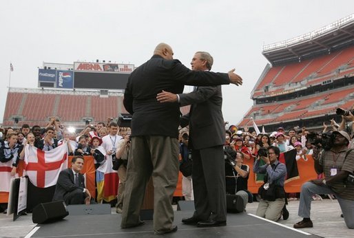 President Bush talks with 1996 Olympic Wrestling silver medalist Iranian-American Matt Ghaffari, before speaking to the Athletes of the International Children's Games and Cultural Festival at the Cleveland Browns Stadium in Cleveland, Ohio, Friday, July 30, 2004. White House photo by Paul Morse.