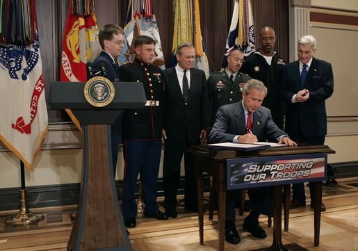 President George W. Bush signs H.R.4613, The Defense Appropriations Act for Fiscal Year 2005, in the Dwight D. Eisenhower Executive Office Building Thursday, Aug. 5, 2004. White House photo by Eric Draper