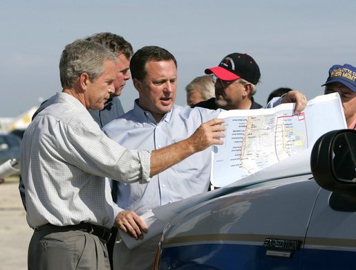 President George W. Bush receives a briefing on hurricane damage from FEMA Director Mike Brown in Punta Gorda, Florida, Sunday, Aug. 15, 2004. White House photo by Eric Draper.