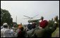 Before attending a meeting with administration officials, Sikh religious and community leaders watch as President George W. Bush departs the White House aboard Marine One Wednesday, Aug. 18, 2004. White House photo by Tina Hager.