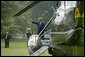 President George W. Bush waves as he departs the South Lawn aboard Marine One Wednesday, Aug. 18, 2004. White House photo by Tina Hager.