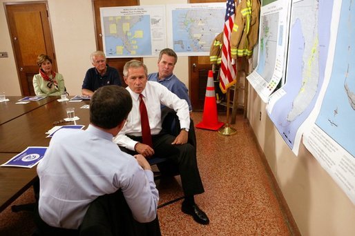 President George W. Bush is briefed by Under Secretary for Emergency Preparedness and Response, Mike Brown, on Tropical Storm Bonnie and Hurricane Charley at the City of Miami Fire House Number Two in Miami, Fla. Also present at the briefing were (from left) Laura Bush, Congressman Bill Young and Governor Jeb Bush, Friday, August 27, 2004. White House photo by Tina Hager