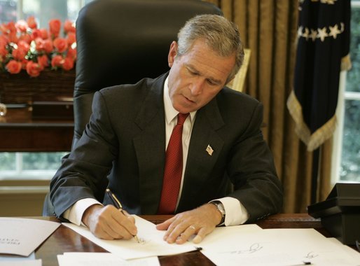 President George W. Bush signs executive orders and directives Friday, August 27, 2004, in the Oval Office, that strengthen the intelligence capabilities of the United States and take action consistent with certain recommendations of the 9/11 Commission. White House photo by Paul Morse
