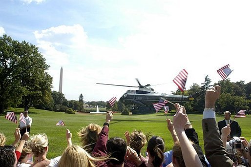 A sea of waving hands and flags bid farewell to President George W. Bush as he departs the South Lawn aboard Marine One Wednesday, Sept. 1, 2004. White House photo by Lynden Steele.