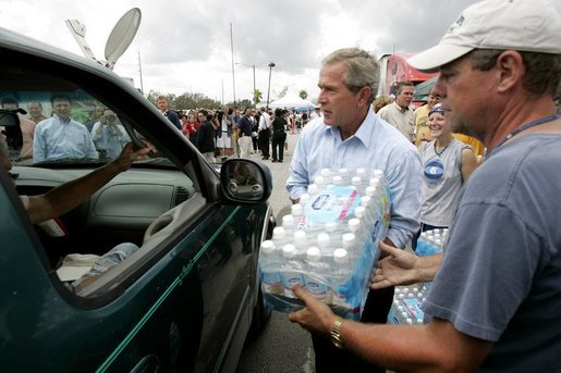 President George W. Bush helps to deliver water to a waiting motorist at an emergency relief center in Ft. Pierce, Fla., while touring relief efforts in response to Hurricane Frances damage, Wednesday, Sept. 8, 2004. White House photo by Eric Draper