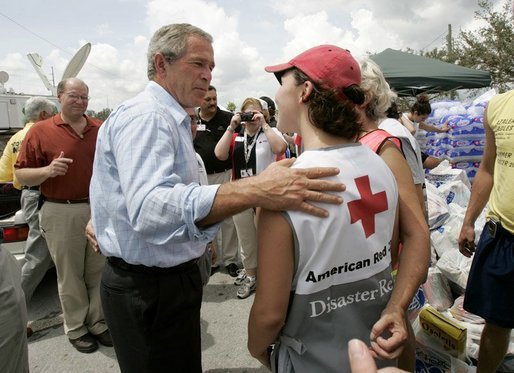 President George W. Bush talks to an American Red Cross worker while touring relief efforts in response to Hurricane Frances damage in Ft. Pierce, Fla., Wednesday, Sept. 8, 2004. White House photo by Eric Draper
