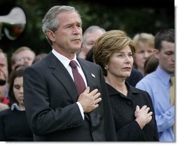 President George W. Bush and Mrs. Bush pause during the playing of Taps following the Moment of Silence on the South Lawn, Saturday, Sept. 11, 2004.  White House photo by Eric Draper