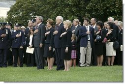 President George W. Bush, Mrs. Bush, Vice President Dick Cheney and Mrs. Cheney, stand by families of victims of 911 during the playing of Taps following a Moment of Silence on the South Lawn, Saturday, Sept. 11, 2004.  White House photo by David Bohrer