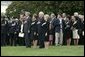 President George W. Bush, Mrs. Bush, Vice President Dick Cheney and Mrs. Cheney, stand by families of victims of 911 during the playing of Taps following a Moment of Silence on the South Lawn, Saturday, Sept. 11, 2004. White House photo by David Bohrer.