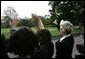 Families of victims of 911 wave goodbye as President George W. Bush and Mrs. Bush depart the White House aboard Marine One, Saturday, Sept. 11, 2004. White House photo by Eric Draper.