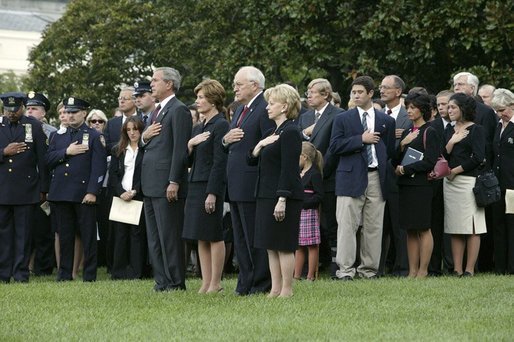 President George W. Bush, Mrs. Bush, Vice President Dick Cheney and Mrs. Cheney, stand by families of victims of 911 during the playing of Taps following a Moment of Silence on the South Lawn, Saturday, Sept. 11, 2004. White House photo by David Bohrer