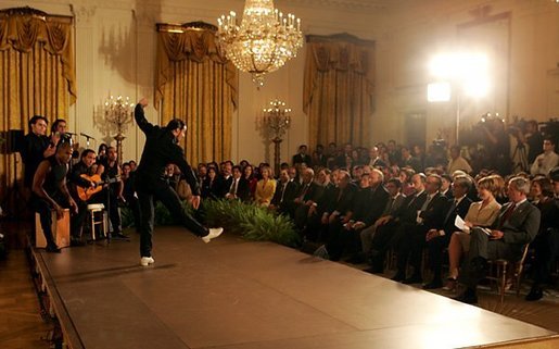 President George W. Bush and Laura Bush watch the performance of Joaquin Cortes as he dances to a quintet of Flamenco musicians during a Hispanic Heritage Month celebration in the East Room of the White House Wednesday, Sept. 15, 2004. White House photo by Joyce Naltchayan