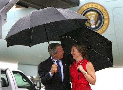 President George W. Bush talks with USA Freedom Corps Greeter Crystal Regan after arriving aboard Air Force One at Charlotte-Douglas International Aiport - Air National Guard Base, Friday, Sept. 17, 2004. Ms. Regan volunteers at East Lincoln Pregnancy Counseling Center, teaching parenting, nutrition, budgeting classes and counseling clients with unplanned pregnancies. White House photo by Eric Draper.