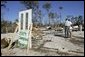President George W. Bush stands with Al Boyd in the ruins of where Boyd's home used to be during a walking tour of neighborhoods damaged by Hurricane Ivan in Pensacola, Florida, Sunday, Sept. 19, 2004. White House photo by Eric Draper