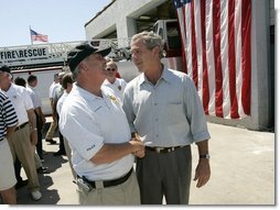 President George W. Bush greets Arthur Bourne, Police Chief of Gulf Shores, during a visit with First Responders at the Orange Beach Fire and Rescue Station 1 in Orange Beach, Alabama Sunday, Sept. 19, 2004.  White House photo by Eric Draper