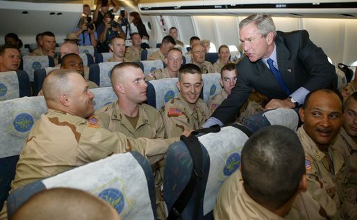 President George W. Bush greets members of two National Guard Units and an active Army unit headed to Iraq during a refueling stop in Bangor, Maine on September 23, 2004. White House photo by Paul Morse