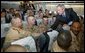 President George W. Bush greets members of two National Guard Units and an active Army unit headed to Iraq during a refueling stop in Bangor, Maine on September 23, 2004. White House photo by Paul Morse